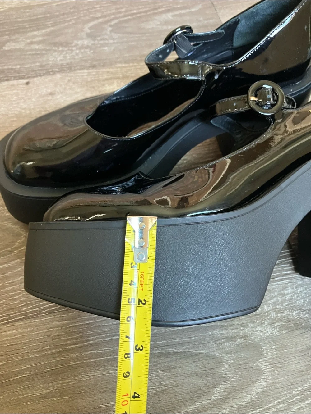 Larroude Olivia Platform Pumps in glossy black patent leather.